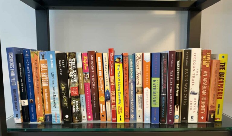 A bunch of excellent travel books on Nomadic Matt's bookshelf