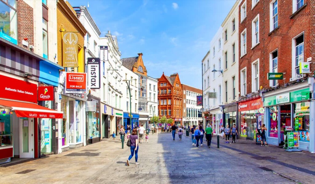 A sunny day in the Old Town of Dublin, Ireland as people walk around and shop