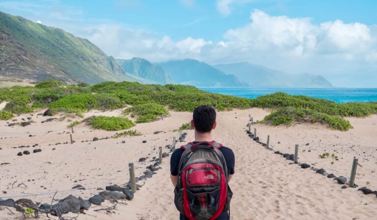 A photo of Nomadic Matt on the beach in Hawaii